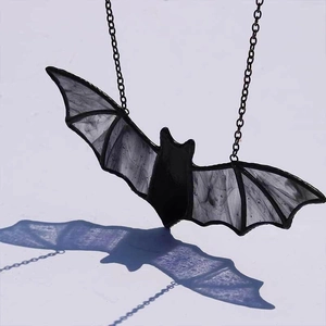 Macro detail of bat suncatcher with translucent purple shadow effect and black chain