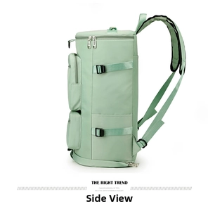 Side view of mint green sports travel bag featuring side pockets and compression straps