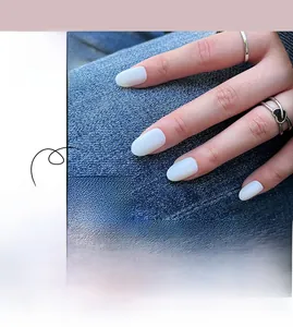 Detail view of matte light blue press-on nails with long oval shape and frosted texture