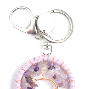 Detailed shot of handmade purple crystal Tree of Life keychain with silver metal clip