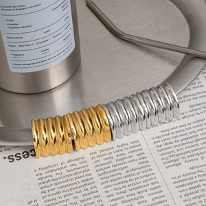 Modern gold and silver ribbed earrings featuring a unique 3D pleated textured design