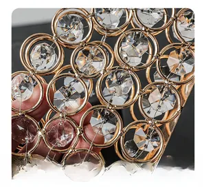 Detail of hand-woven gold metal rings with hexagonal cut clear crystal inlay for tissue holder