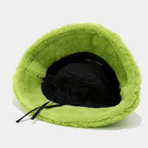 Close-up of bright green fuzzy bucket hat showing black interior lining and adjustable drawstring