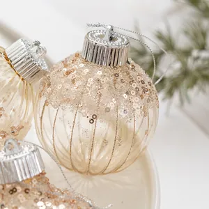 Champagne gold Christmas ornaments with glitter details and vertical ribbed textures