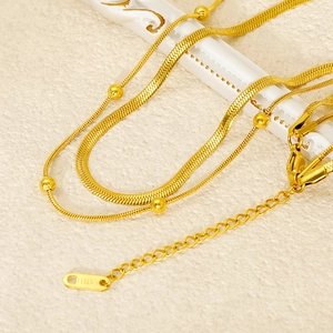 Minimalist double-layered stainless steel necklace with snake chain and gold beads detail