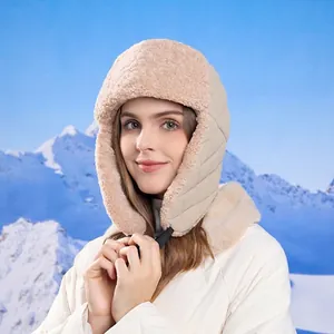 Winter thermal beige bomber hat with quilted pattern and warm fleece lining on snowy background