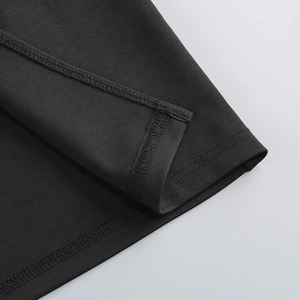 Detail of professional overlock stitching on the hem of a black halter party dress