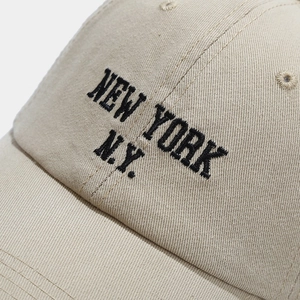 Classic beige cotton baseball cap with New York N.Y. embroidery on a neutral background