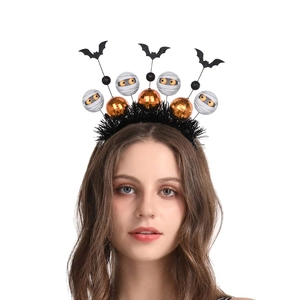 Halloween headband with orange balls mummy and black bat on a feather base worn by model