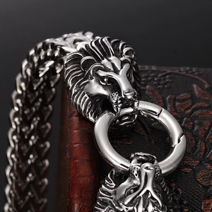 Men's stainless steel woven bracelet featuring detailed lion head claps and a circular ring