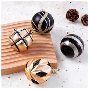 Detail of black and gold Christmas balls with glitter patterns on a wooden tray