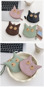 Close-up of four colorful PU leather cat-shaped coin purses with metal zippers