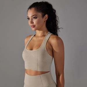 Detail of light brown seamless sports bra with wide straps and breathable knit fabric