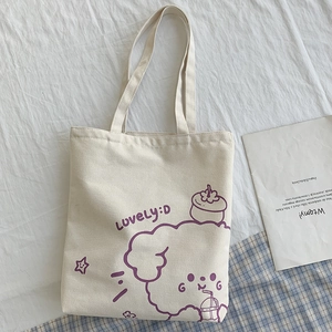 Detail of off-white canvas tote bag with a purple cartoon poodle and LOVELY:D print