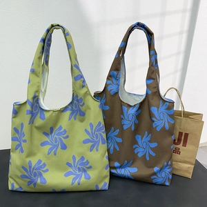 Detail view of large floral canvas tote bag featuring wide handles for daily commute