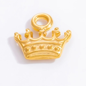 Detail of 18k gold plated crown pendant accessory with polished metal finish