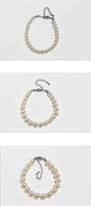 Detailed view of cream white pearl bracelet with silver lobster clasp and extender chain