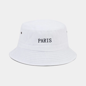 Detail of white canvas bucket hat with black PARIS embroidery and metal eyelets