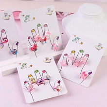 Close-up of colorful resin cartoon rings with adjustable metal bands for kids