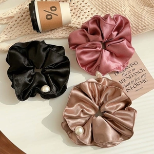 Three premium satin scrunchies in black, rose pink and champagne with elegant pearl detail