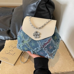 Star-patterned denim handbag with fringe details and silver chain strap for women