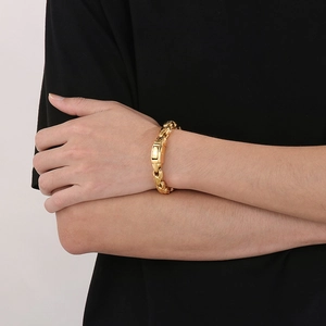 Close-up of a 10mm golden vacuum plated stainless steel link chain bracelet on wrist