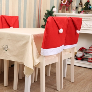 Christmas dining chair covers in red Santa hat design with white pom-poms for festive decor