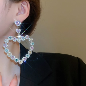 Gros plan de boucles d'oreilles en forme de cœur avec des cristaux étincelants colorés