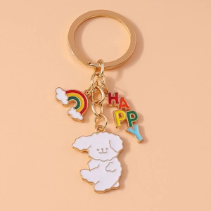 Detail of metal keychain with golden ring, white dog pendant, and colorful rainbow charm