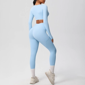 Sky blue yoga set with long sleeve crop top and high waist leggings featuring side pockets