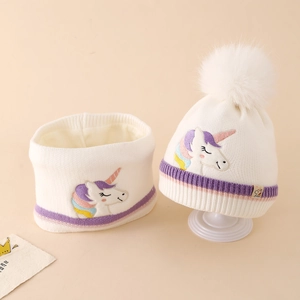 Detail of white unicorn embroidery on kids knit hat and scarf set with stripes