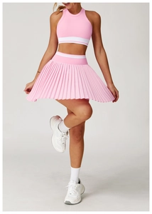 Detail of pink pleated tennis skirt with white stripes and breathable ribbed sports vest