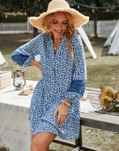 Close-up of blue floral shirt dress featuring elegant lace patchwork on long sleeves