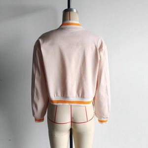 Rear view of pink cropped jacket featuring orange and white striped ribbed trim detailing