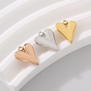 Polished stainless steel heart pendants in gold, silver, and rose gold finishes