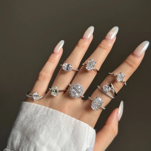 Detailed view of eight assorted S925 silver rings with various gemstone cuts on a hand