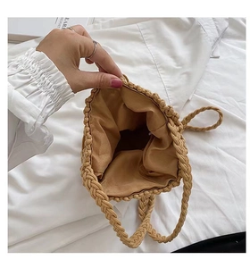 Detail view of woven bucket bag featuring soft fabric lining and handmade texture