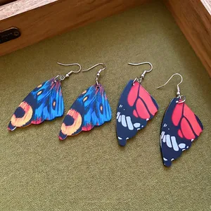 Exaggerated acrylic butterfly wing dangle earrings with vibrant nature-inspired textures