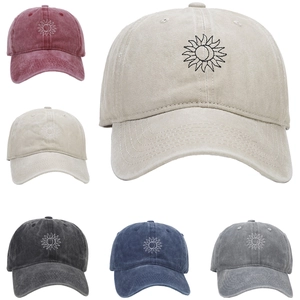 Detail of washed cotton baseball caps with sun and moon embroidery in five vintage colors
