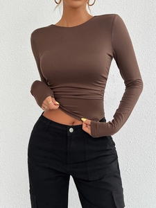 Close-up of slim fit brown long sleeve knitted Y2K top with round neck for women