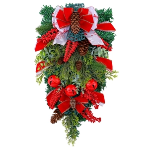 Christmas teardrop wreath with red bow, pine cones, berries and bells on pine branches