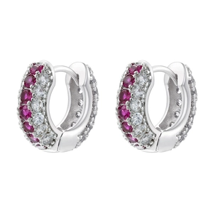 Detail of silver huggie earrings with dual rows of pink and white cubic zirconia crystals
