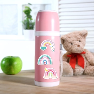 Close-up of cute rainbow stickers on a pink insulated water bottle with carrying strap