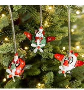 Christmas tree ornaments featuring Santa, snowman, and reindeer flying metal airplanes