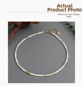 Detailed shot of white shell beads with gold brass spacers and adjustable lobster clasp