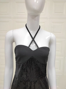 Detail of cross halter neck and sequin patchwork on a black slim fit dress