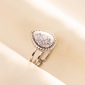 Close-up of adjustable double-band silver ring with teardrop white turquoise gemstone