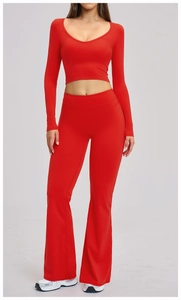 Detail of high-waist flared yoga pants and U-neck cropped long sleeve top in red