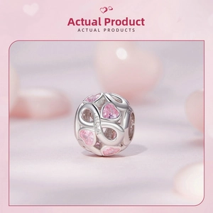 Macro detail of S925 silver charm with pink heart crystals and MOM engraving