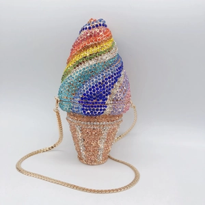 Macro view of crystal rhinestones on rainbow ice cream clutch with gold chain strap